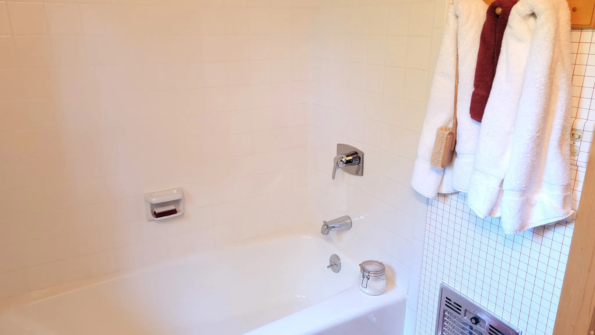 Ceramic tiled tub surround and porcelain tub/shower.