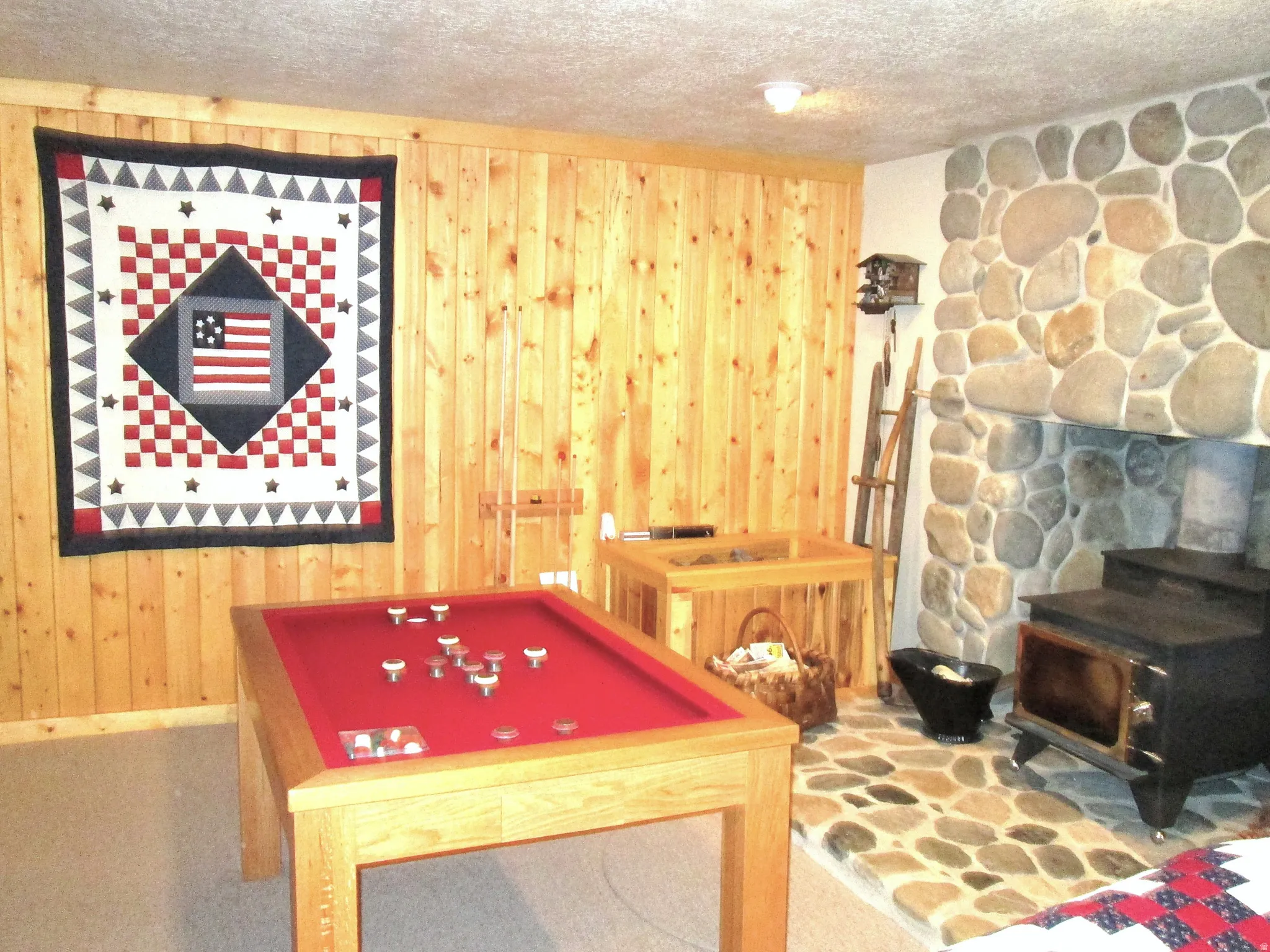 The bumper pool table was custom built for the cabin and has a slate base, and a matching wooden cover top for multiple uses.