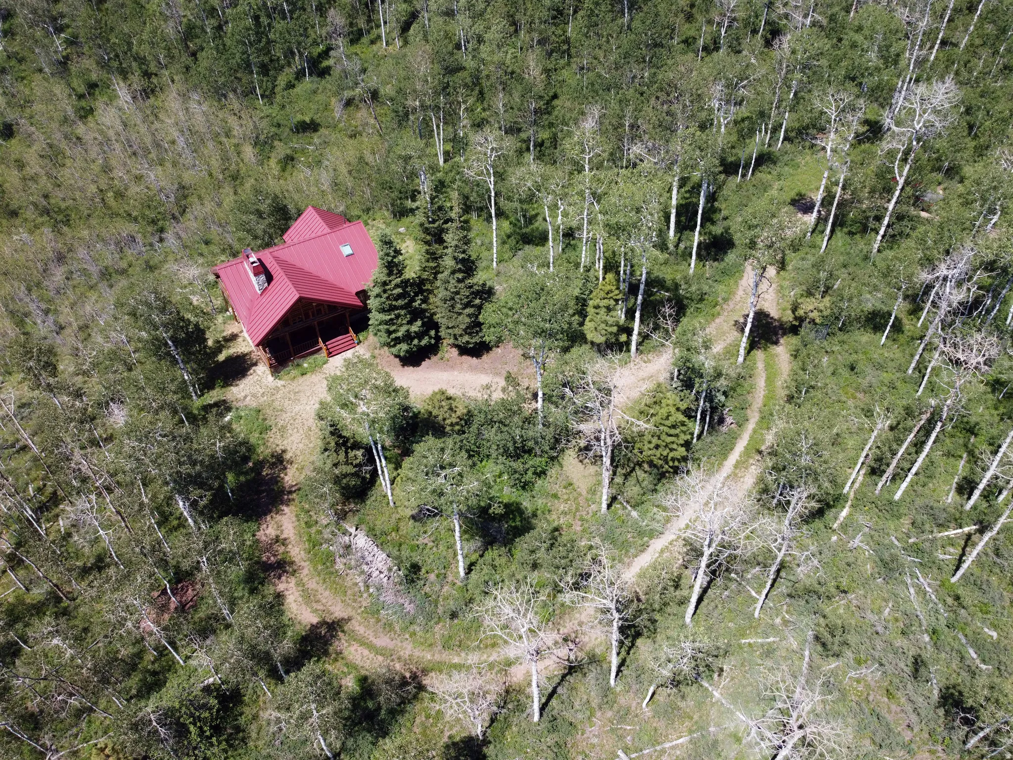The Perfect Mountain Retreat!  Nestled on 5 wooded acres in beautiful Weber Canyon! Aerial view of the circular driveway.