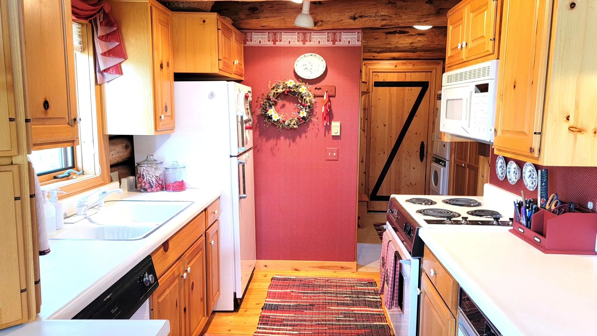 Kitchen view 2: Kitchen and laundry/mud room& back door.
