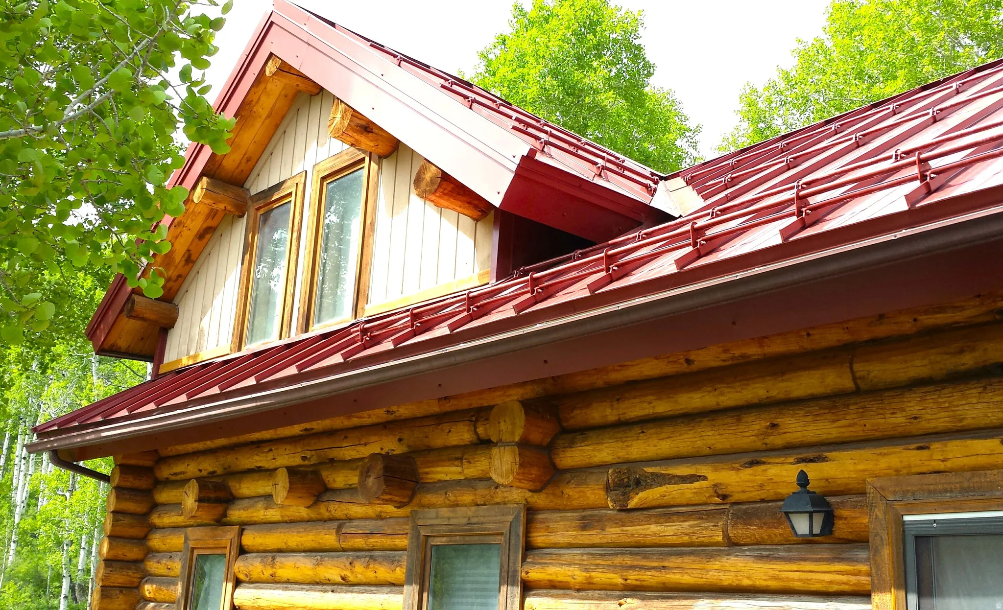 The cabin has a newer red heavy duty standing steel roof, with and heavily engineered snow guards for safety, to keep snow from sliding off the roof.