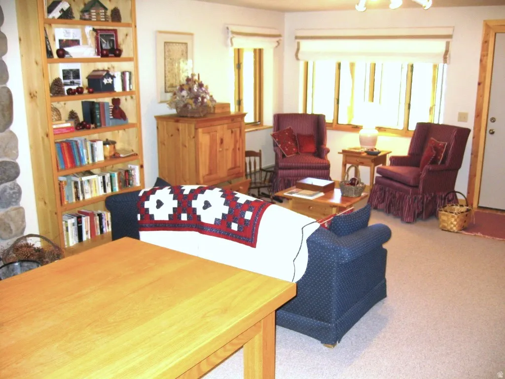 Looking from the bumper pool table to the seating area and door to the outside.