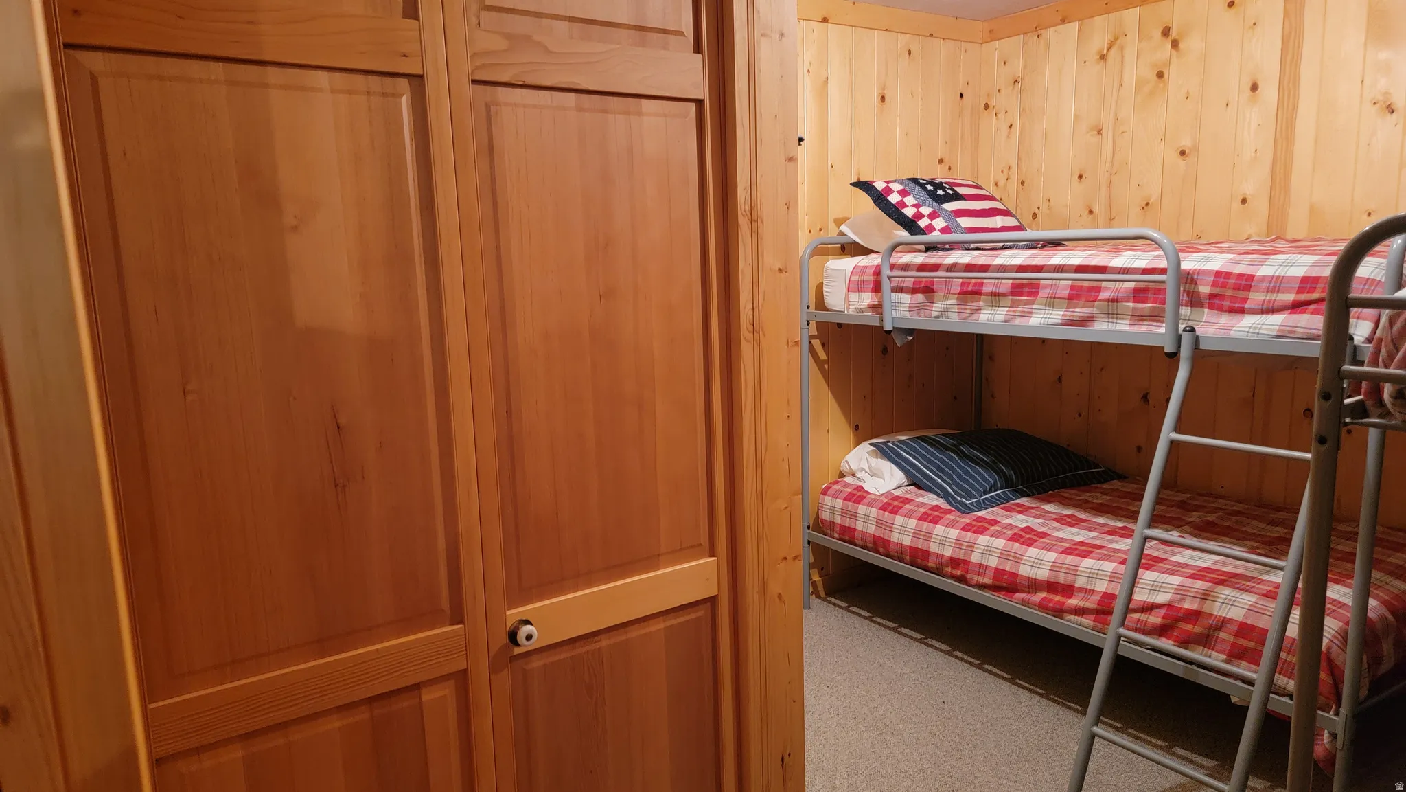 The bunk room closet. The bunk room has wool Berber carpet and baseboard heating.
