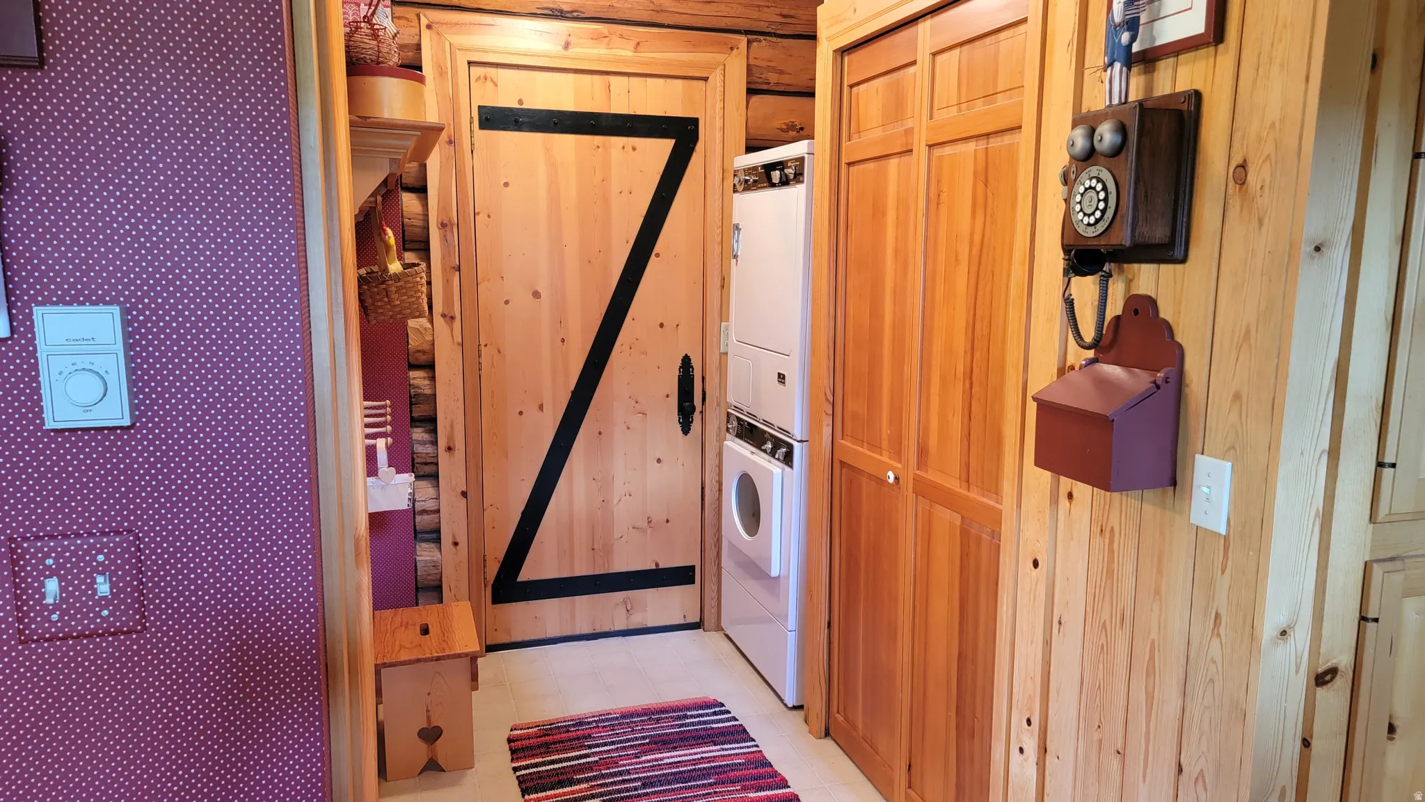 Washroom/ mud room with east side entrance to the cabin. There is a full bath to the left of the door.