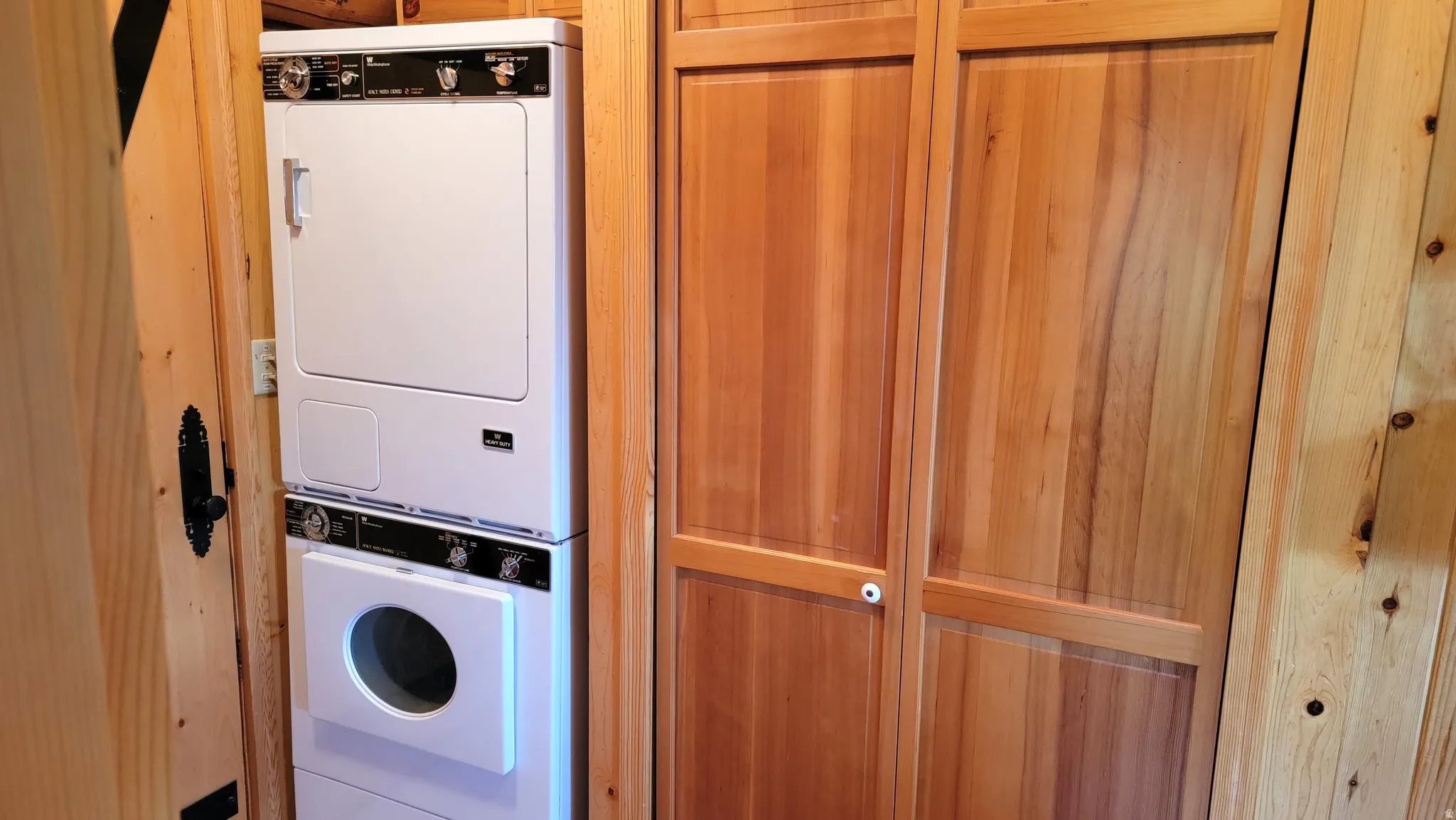 Laundry room with stacked washer and dryer.