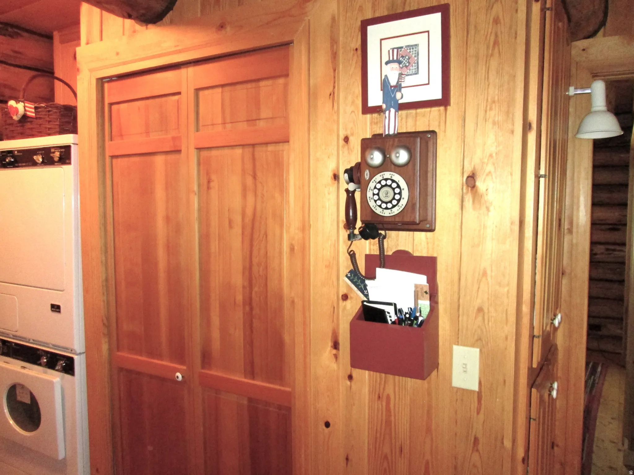 The laundry room has a deep utility closet and vintage working phone.