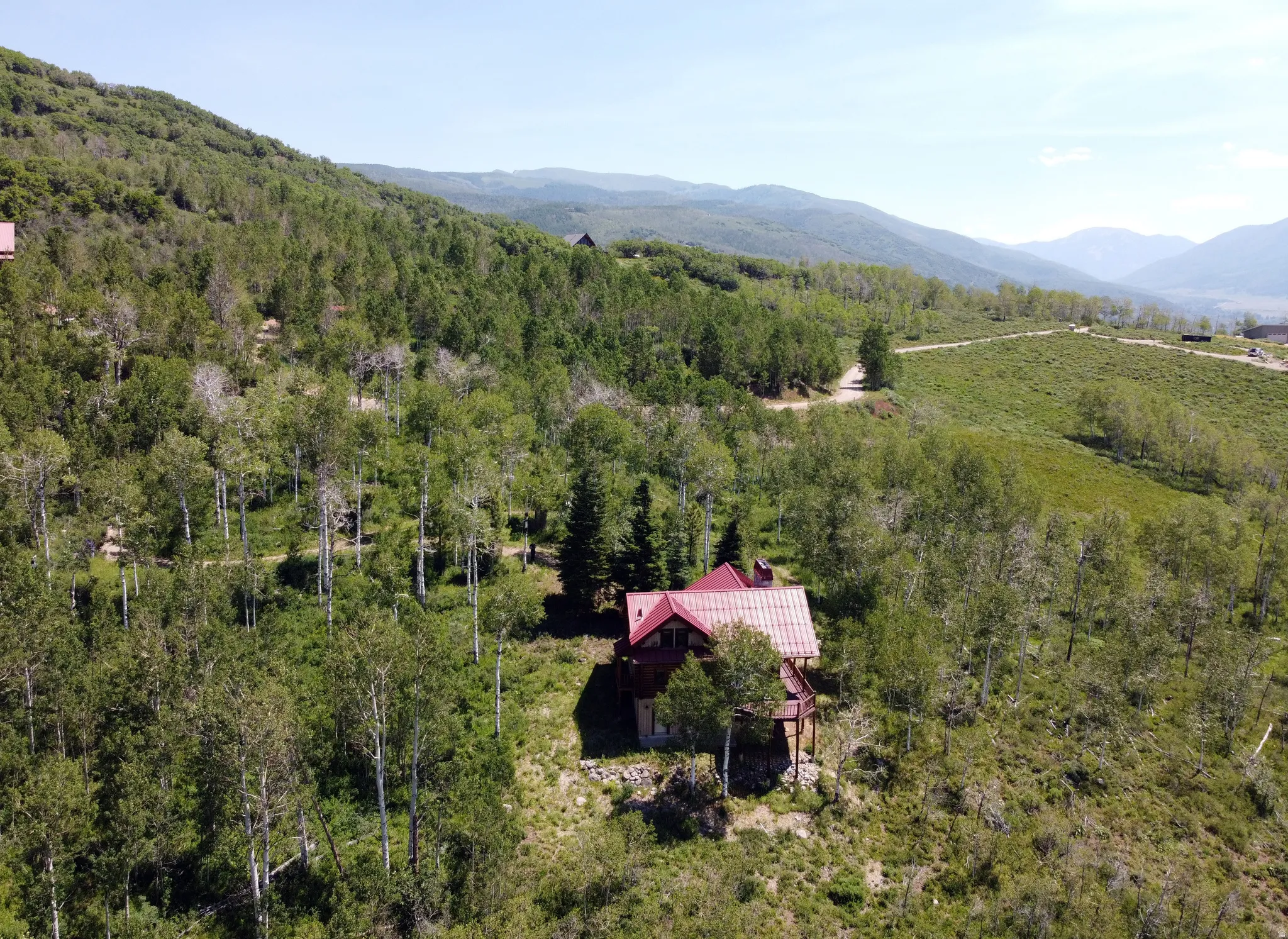 Aerial view back of cabin and surrounding  area.