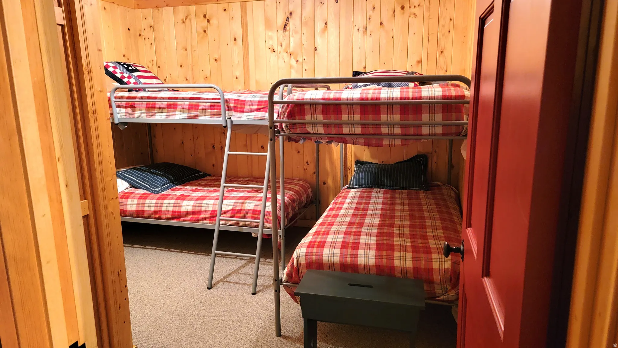 The lower level bunk room with 2 sets of twin beds. Bunk room has no window. There are 2 outside exit doors close by in the family room and the utility room.