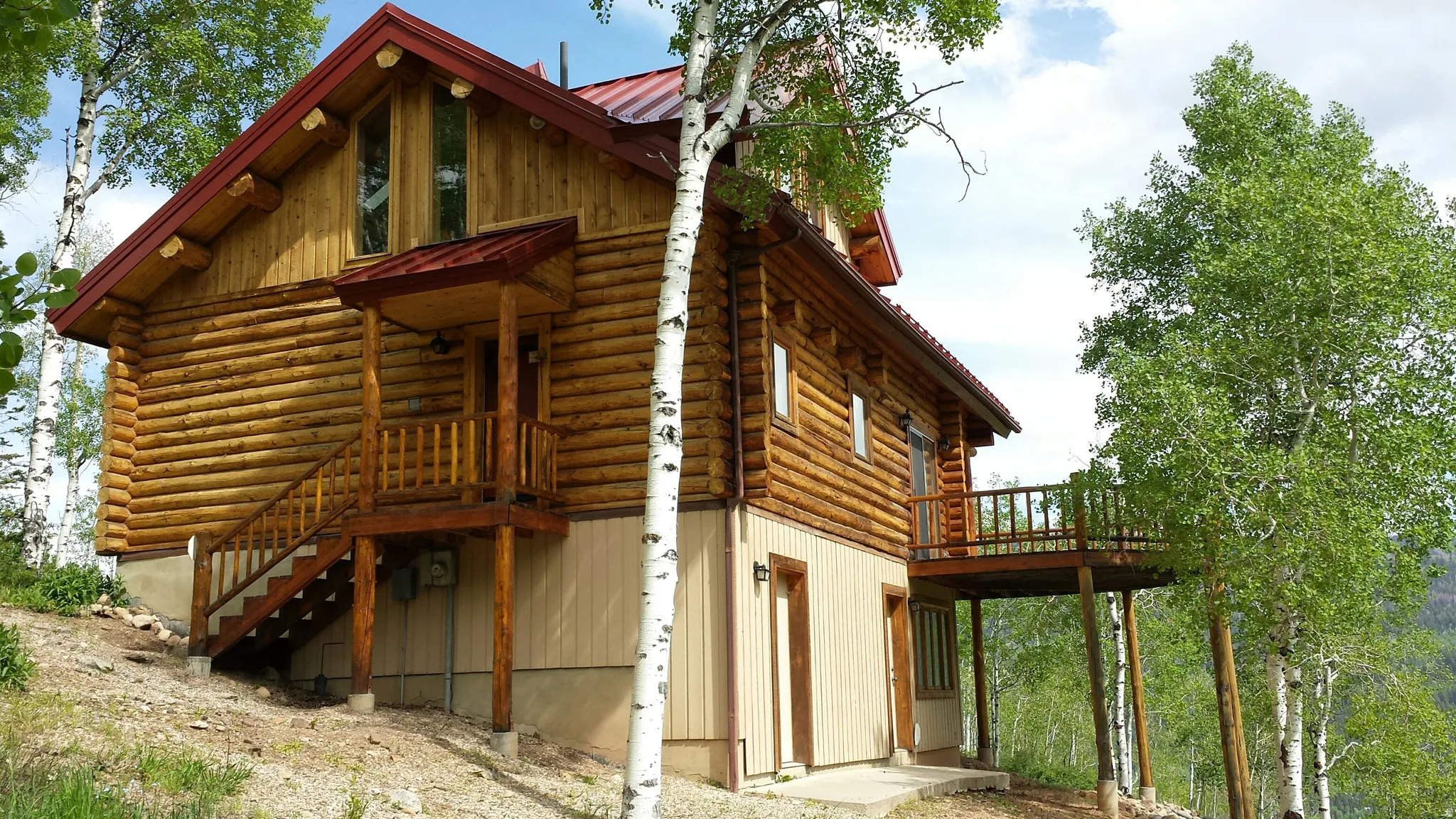 The east and west side of the cabin, showing the back deck and doors to the family room and utility room.