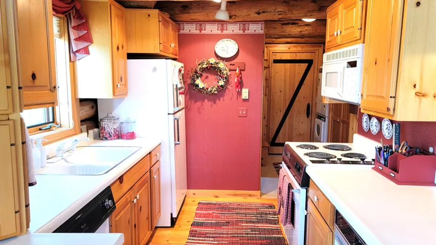 Kitchen view 2: Kitchen and laundry/mud room& back door.