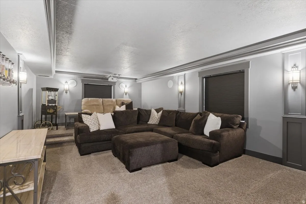 Large theater room featuring, recessed lighting, wall sconces, full projection and sound system