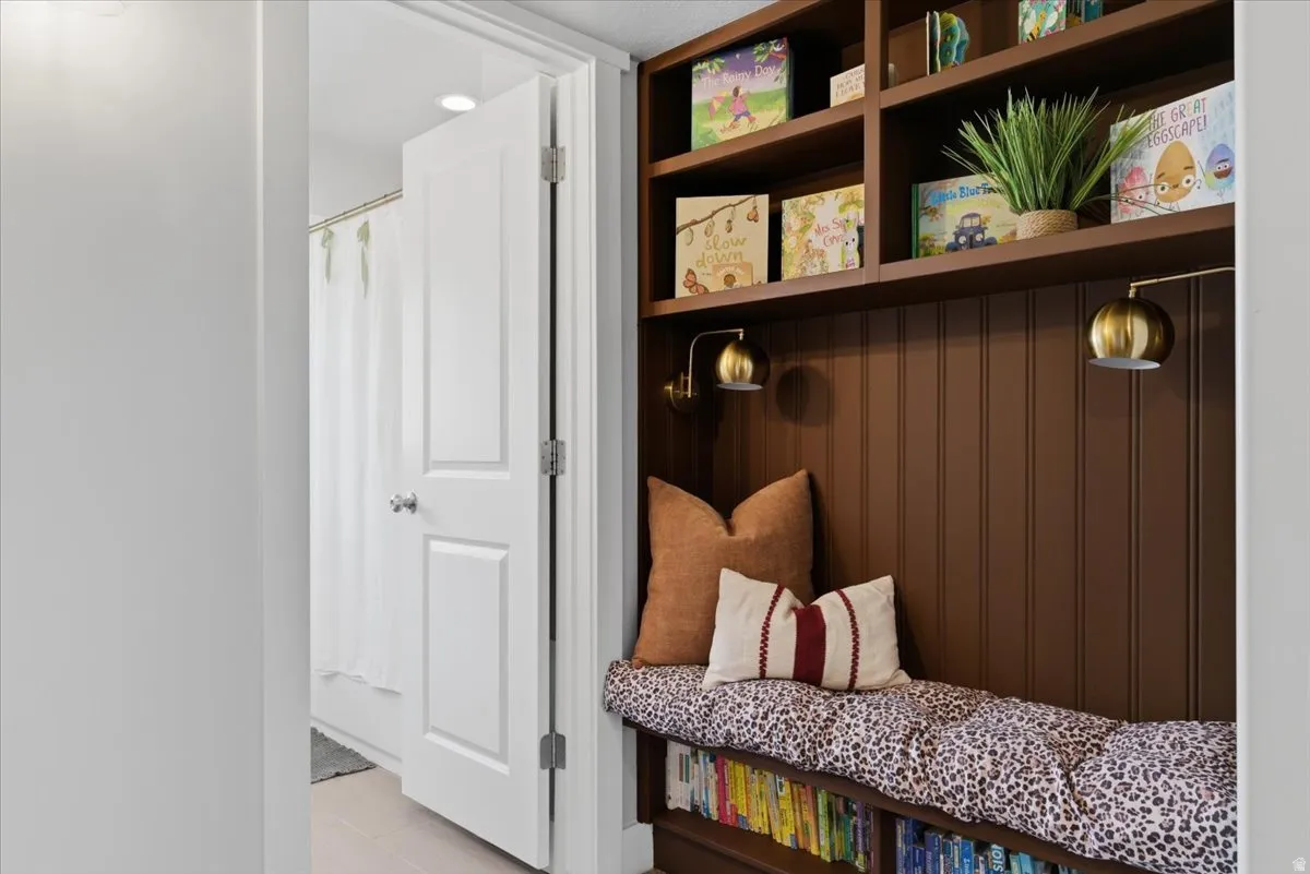 Book nook with built-in shelving with integrated seating, beadboard backing
