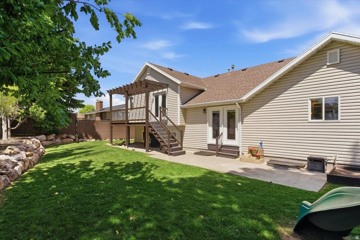 Expansive backyard featuring a manicured lawn, private pergola walkout from master bedroom and mature trees