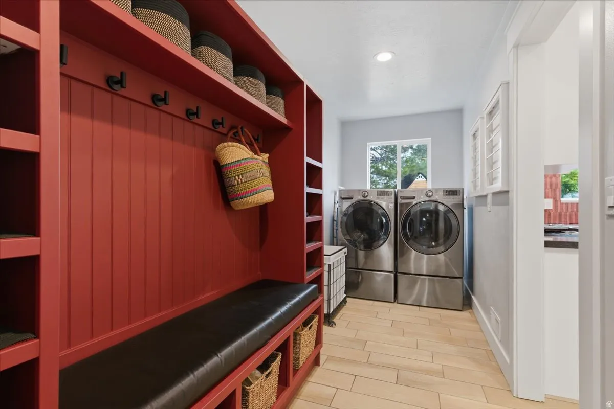 Mudroom featuring a built-in bench with storage, beadboard paneling, included washer and dryer