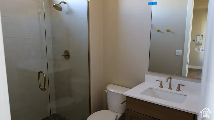 Modern bathroom featuring a frameless glass-enclosed shower with brushed nickel hardware, white subway tile surround, and a floating vanity with an undermount sink and brushed nickel faucet