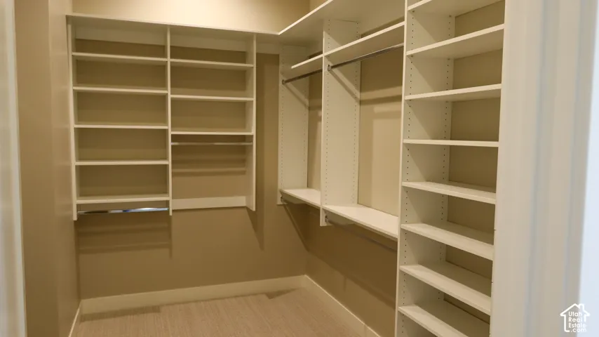 Integrated closet system featuring multiple shelving units, hanging rods, and built-in storage