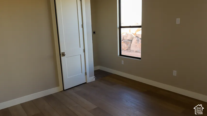 Wood-finish flooring with neutral wall paint and white trim