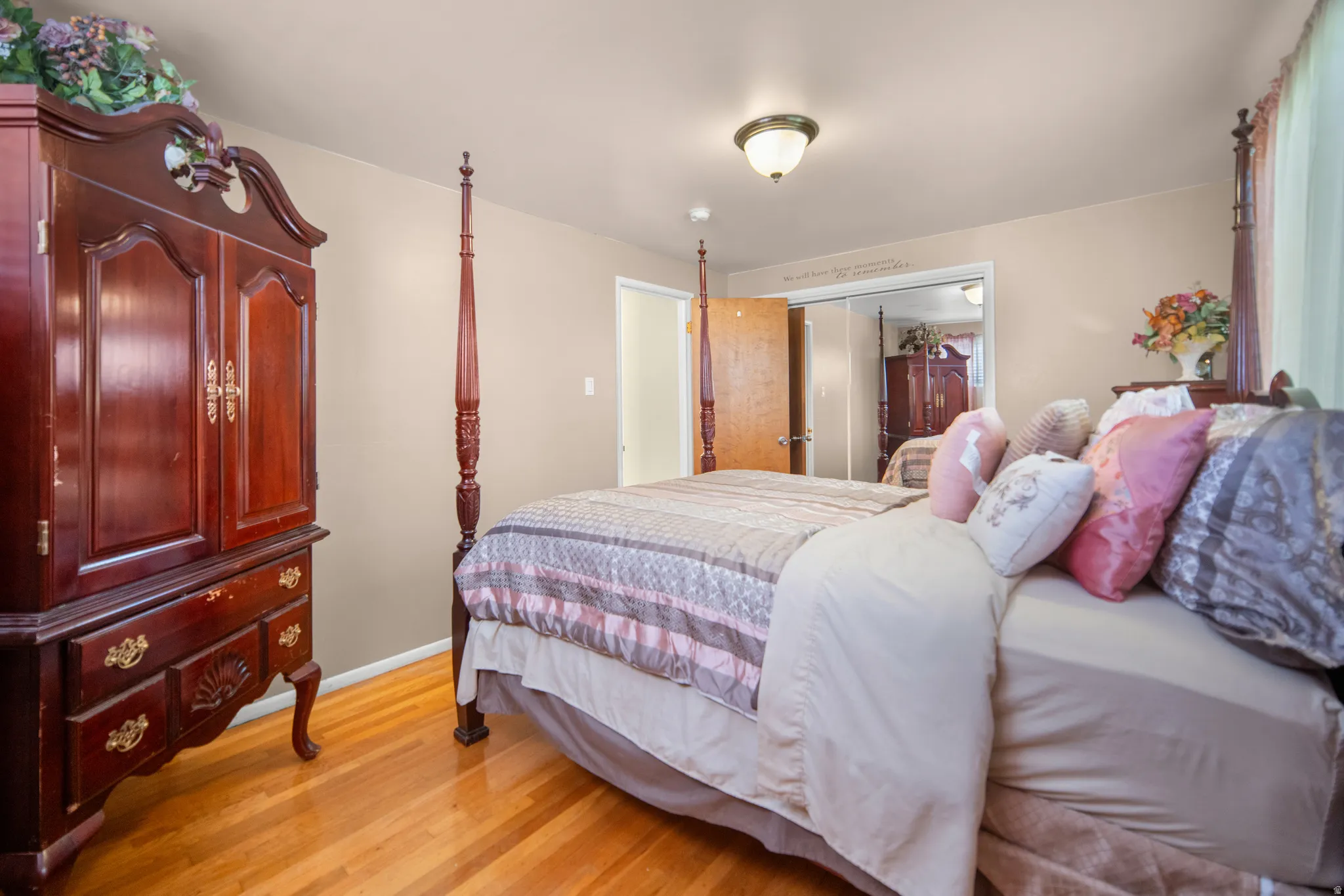 Hardwood flooring throughout, neutral wall tones, and ceiling-mounted light fixture