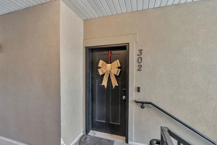 Entry door featuring a traditional panel design and modern door hardware