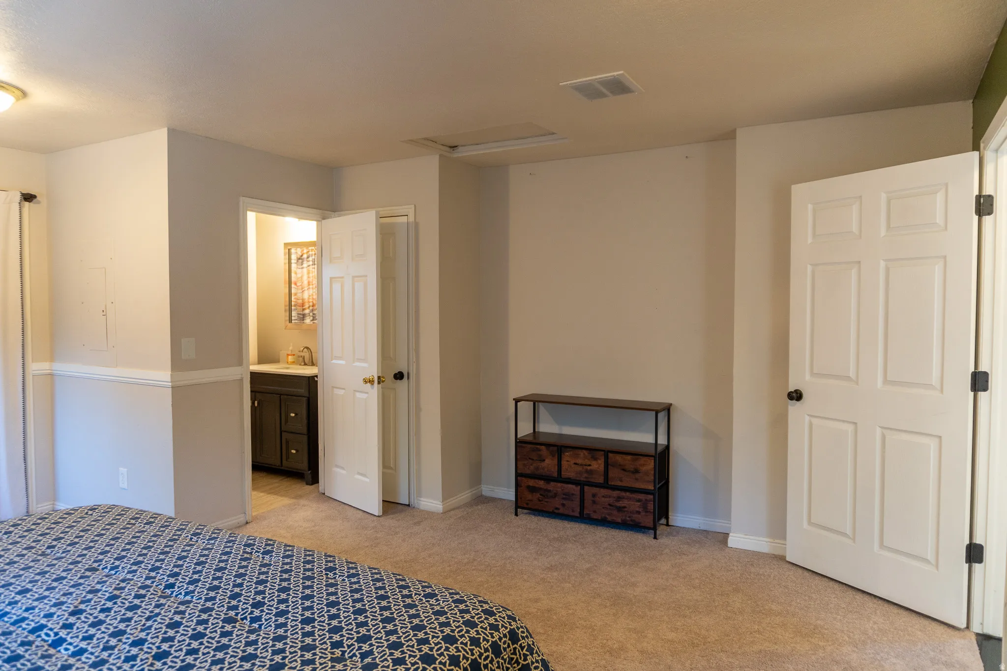 Carpeted room with neutral wall tones and white trim