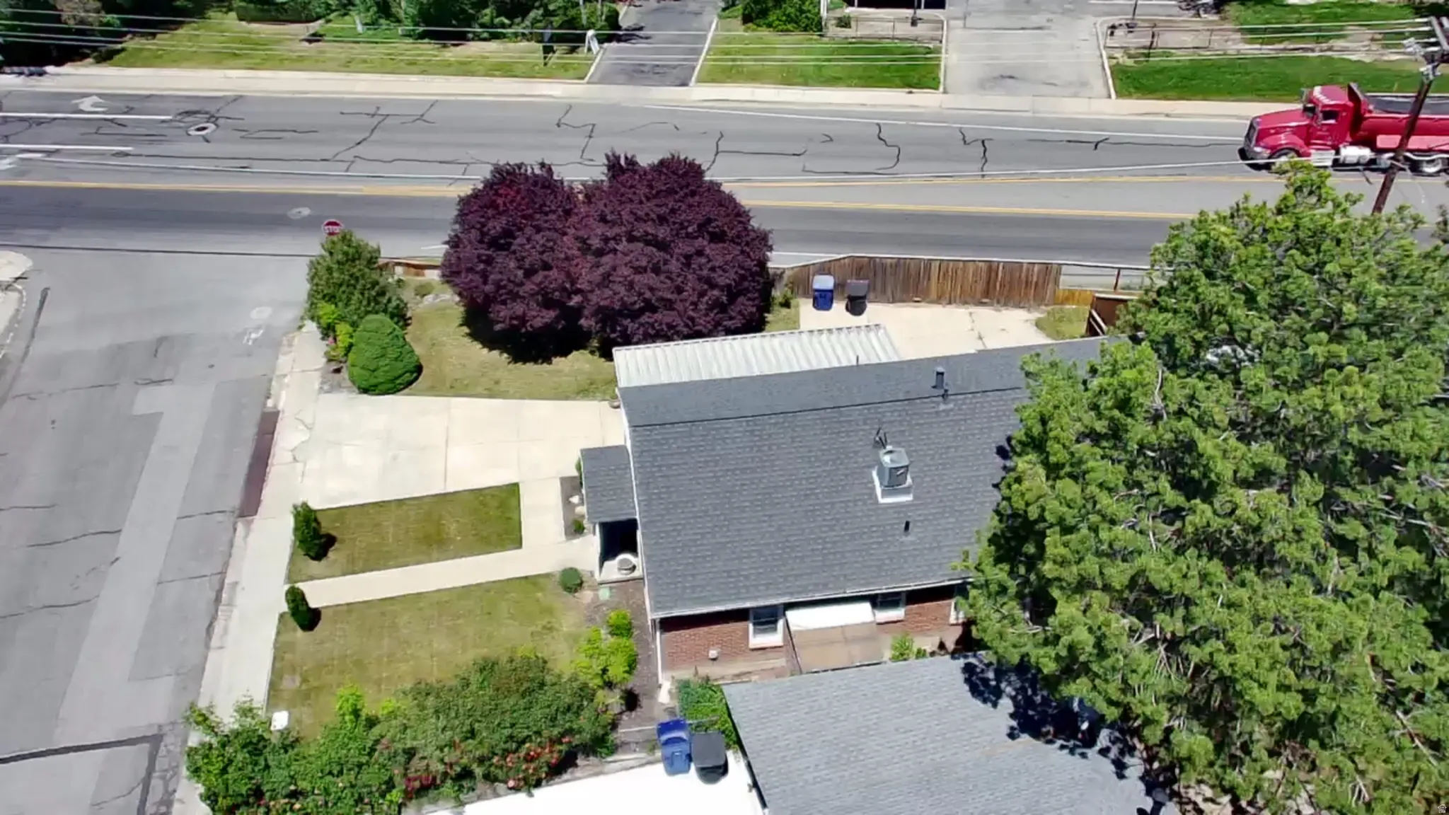 Brick-clad residence with a dark shingle roof and a prominent chimney