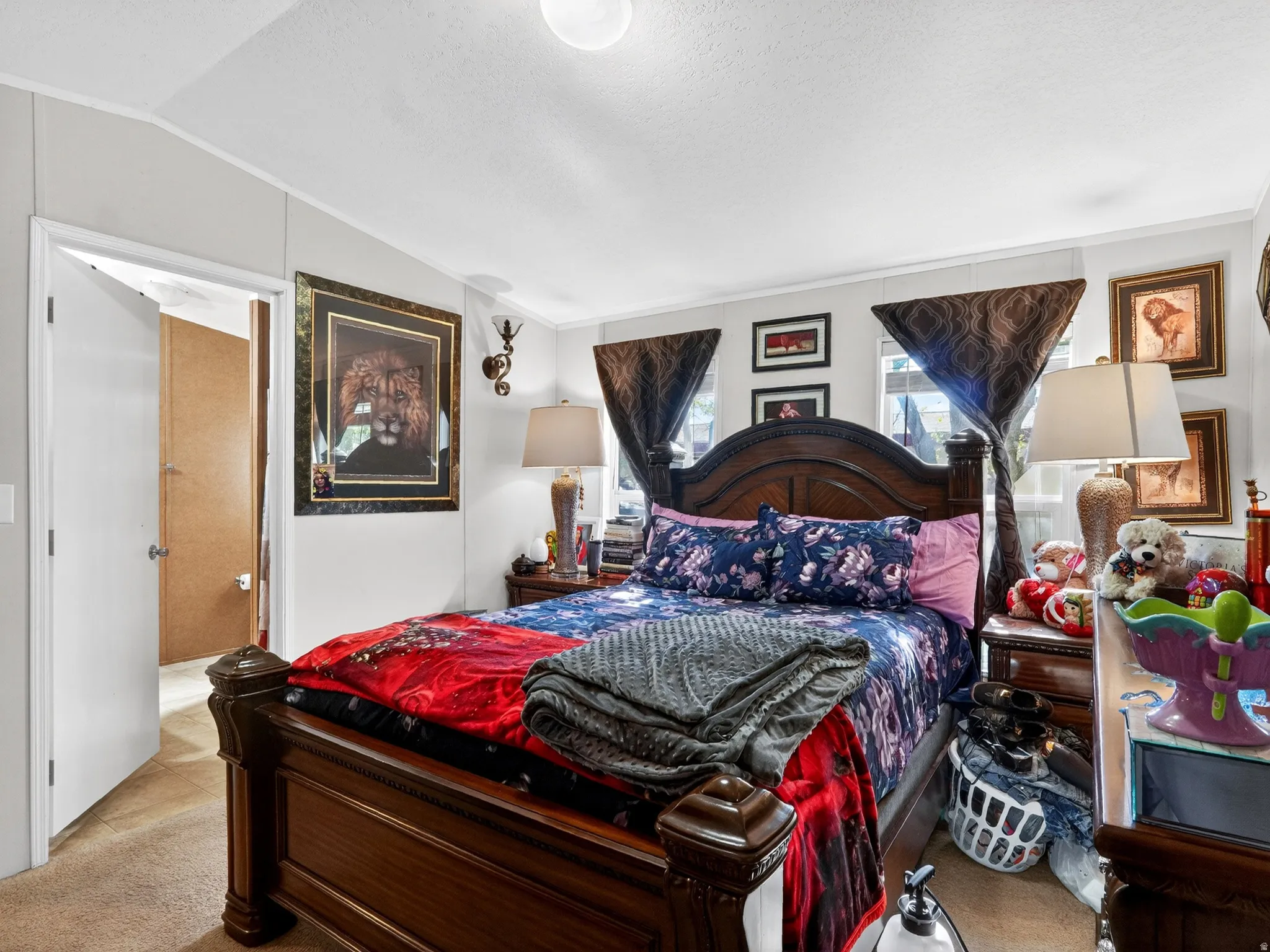 Bedroom featuring a paneled accent wall, carpet flooring, and a ceiling light fixture