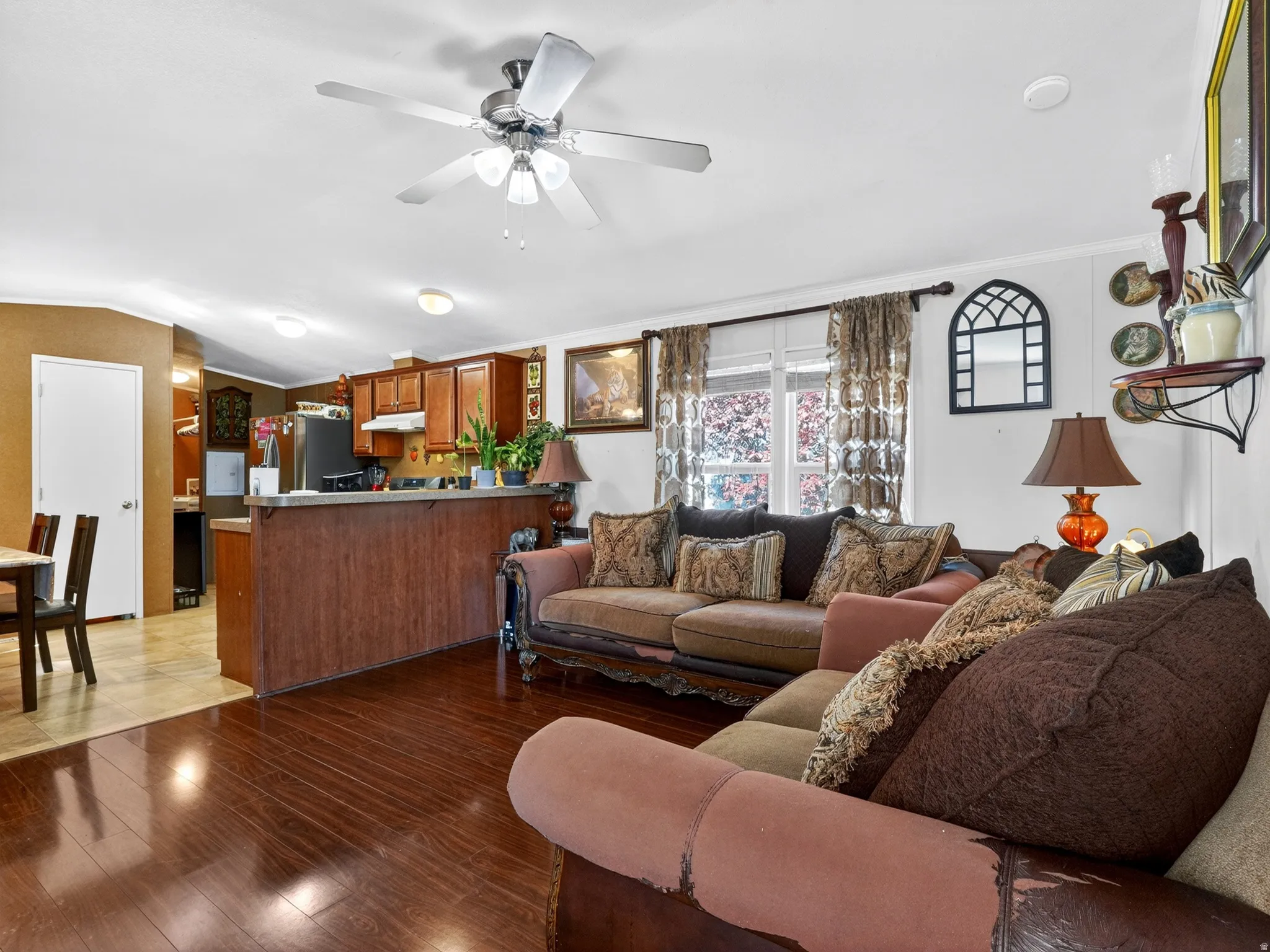 Open concept living area featuring wood-finish flooring and a ceiling fan