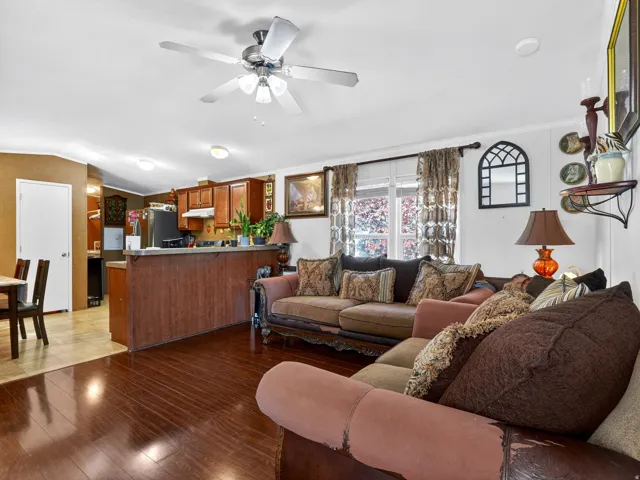 Open concept living area featuring wood-finish flooring and a ceiling fan