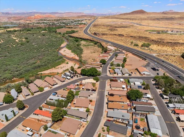 Aerial perspective of a residential neighborhood with a winding river and desert landscape