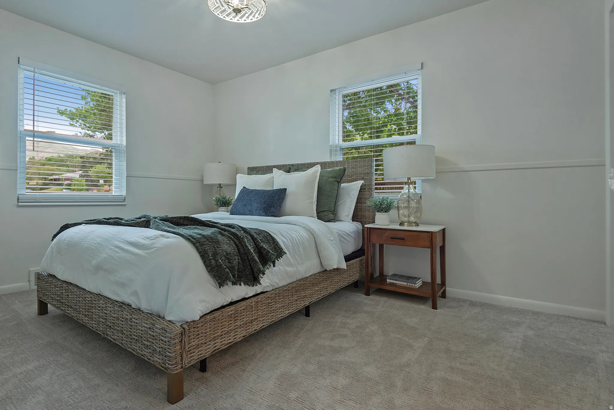 Carpeted room with two windows featuring blinds