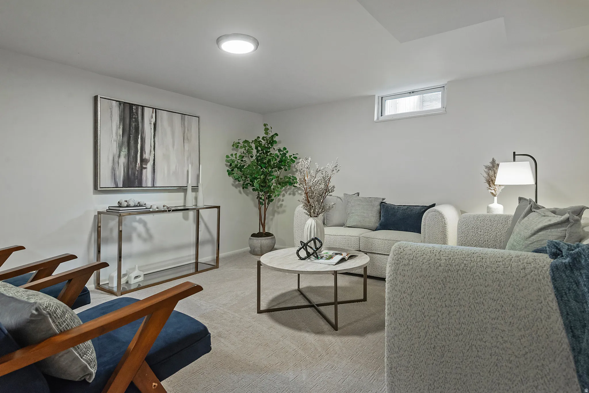 Carpeted living area featuring recessed ceiling lighting and a high-set window
