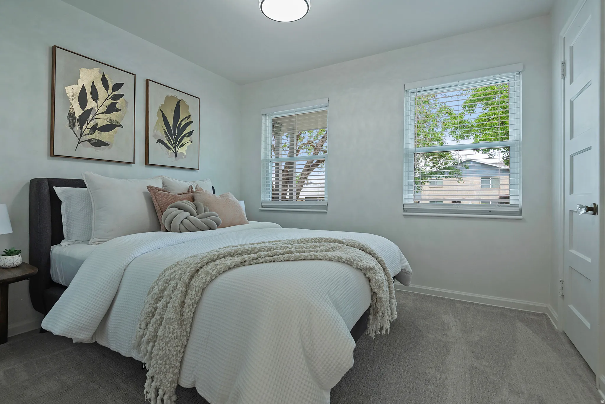 Room featuring light gray walls and plush carpet flooring