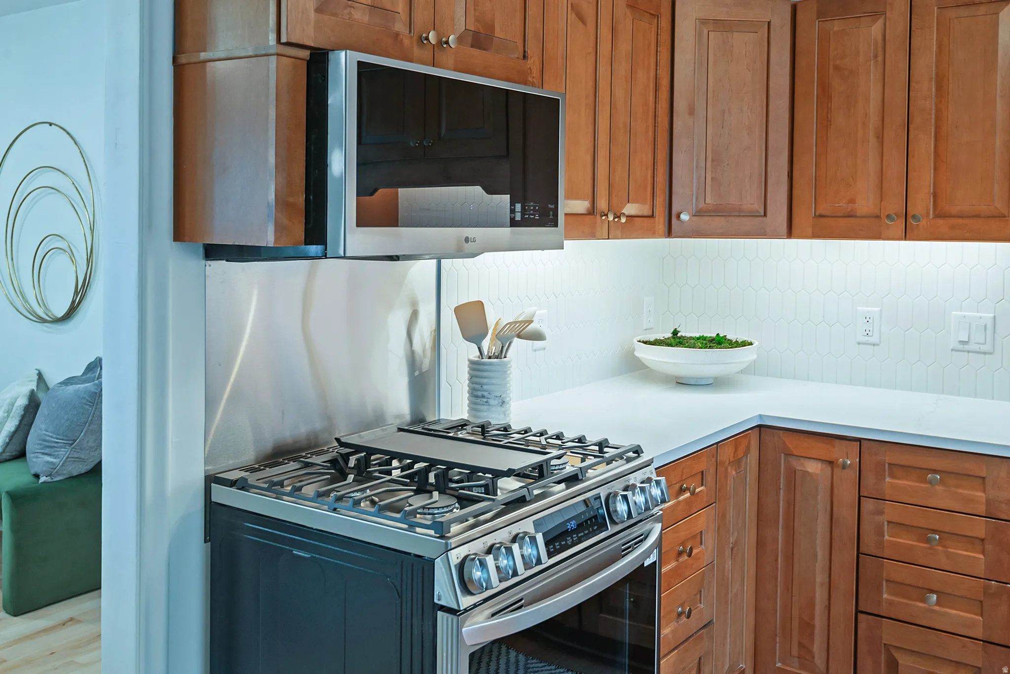 Stainless steel gas range with coordinating over-the-range microwave