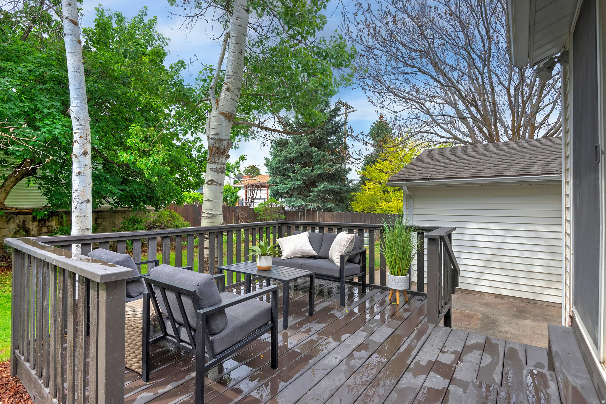 Spacious outdoor deck with dark wood-finish flooring and matching railings