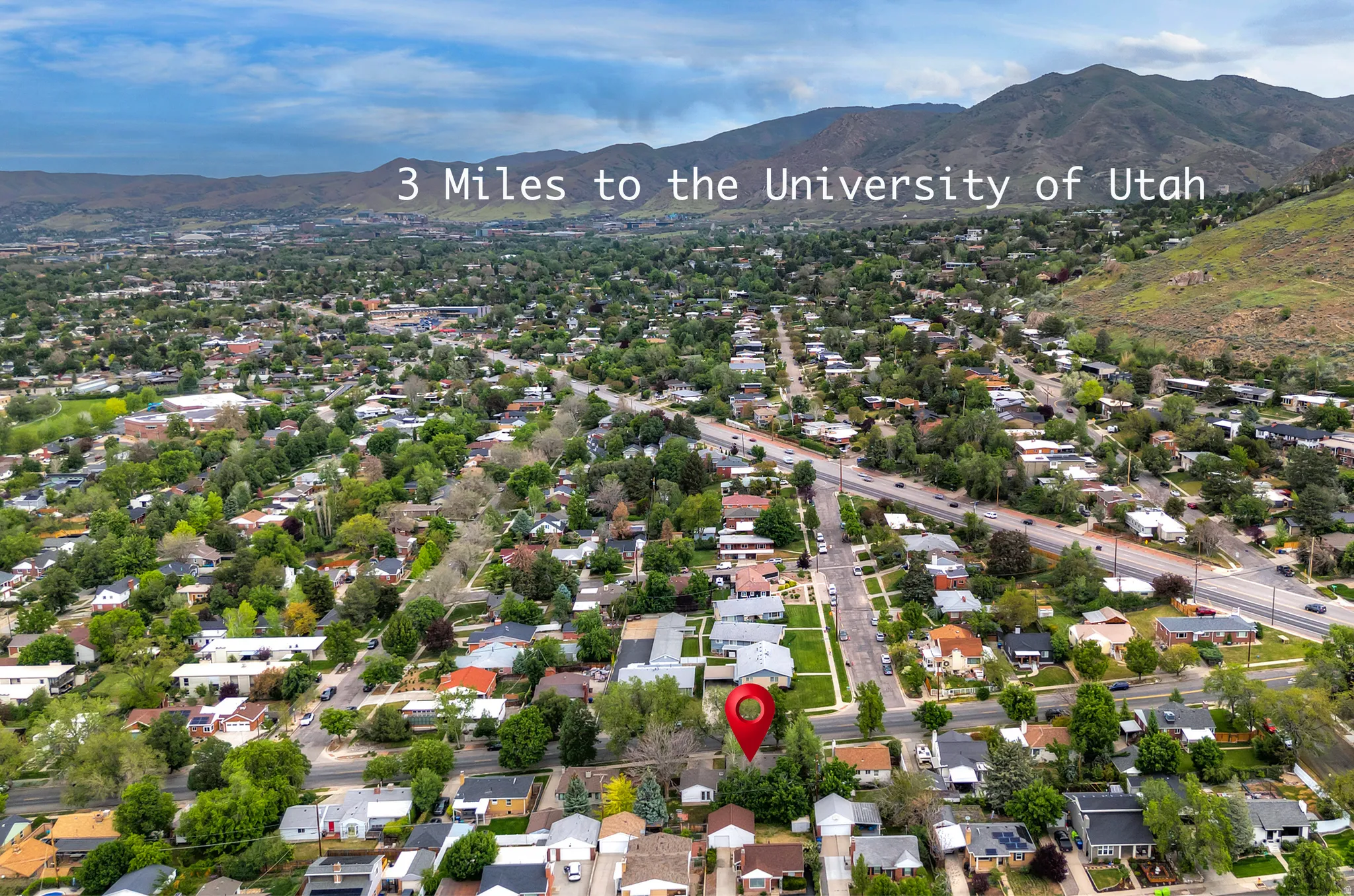 Residential neighborhood with tree-lined streets, situated at the base of a mountain range