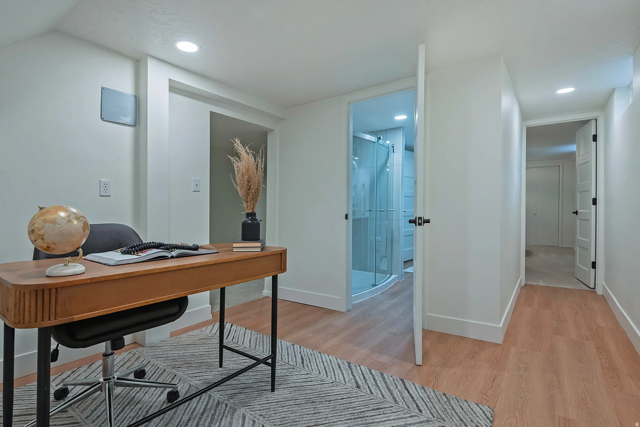 Versatile space featuring wood-finish flooring and recessed lighting
