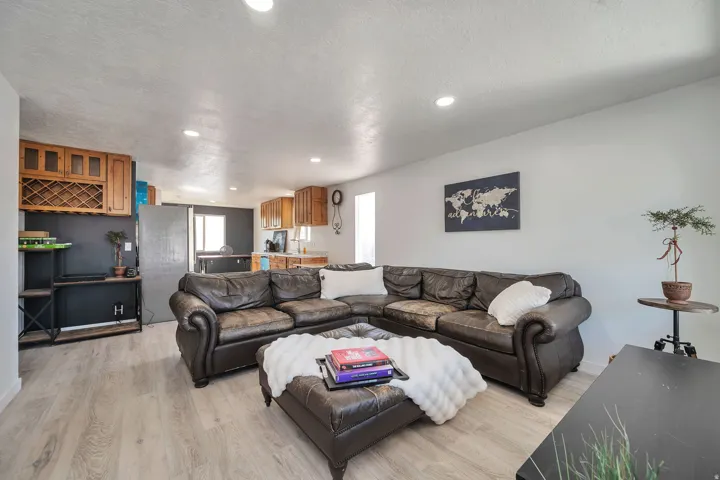 Open-concept living area with light wood-finish flooring