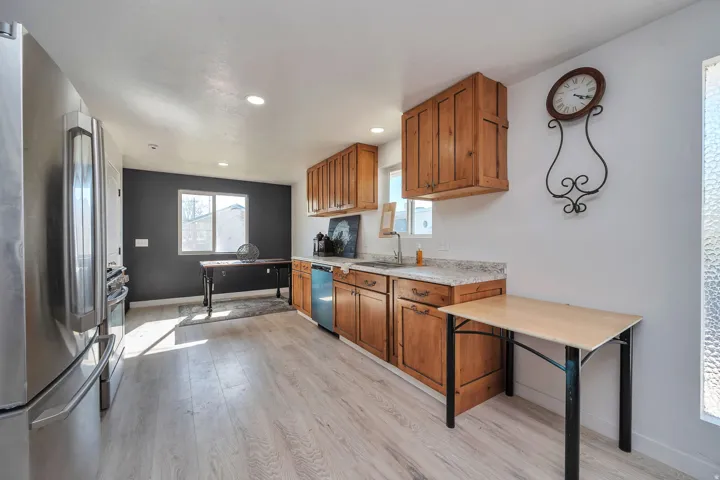 Kitchen featuring wood-finish flooring, recessed lighting, and a stainless steel refrigerator