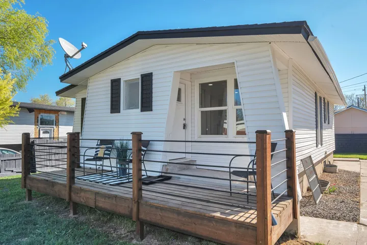 White siding exterior with a black trim roofline