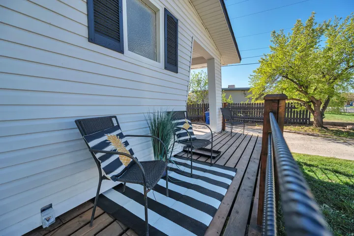 Front porch featuring wood flooring and a white siding exterior