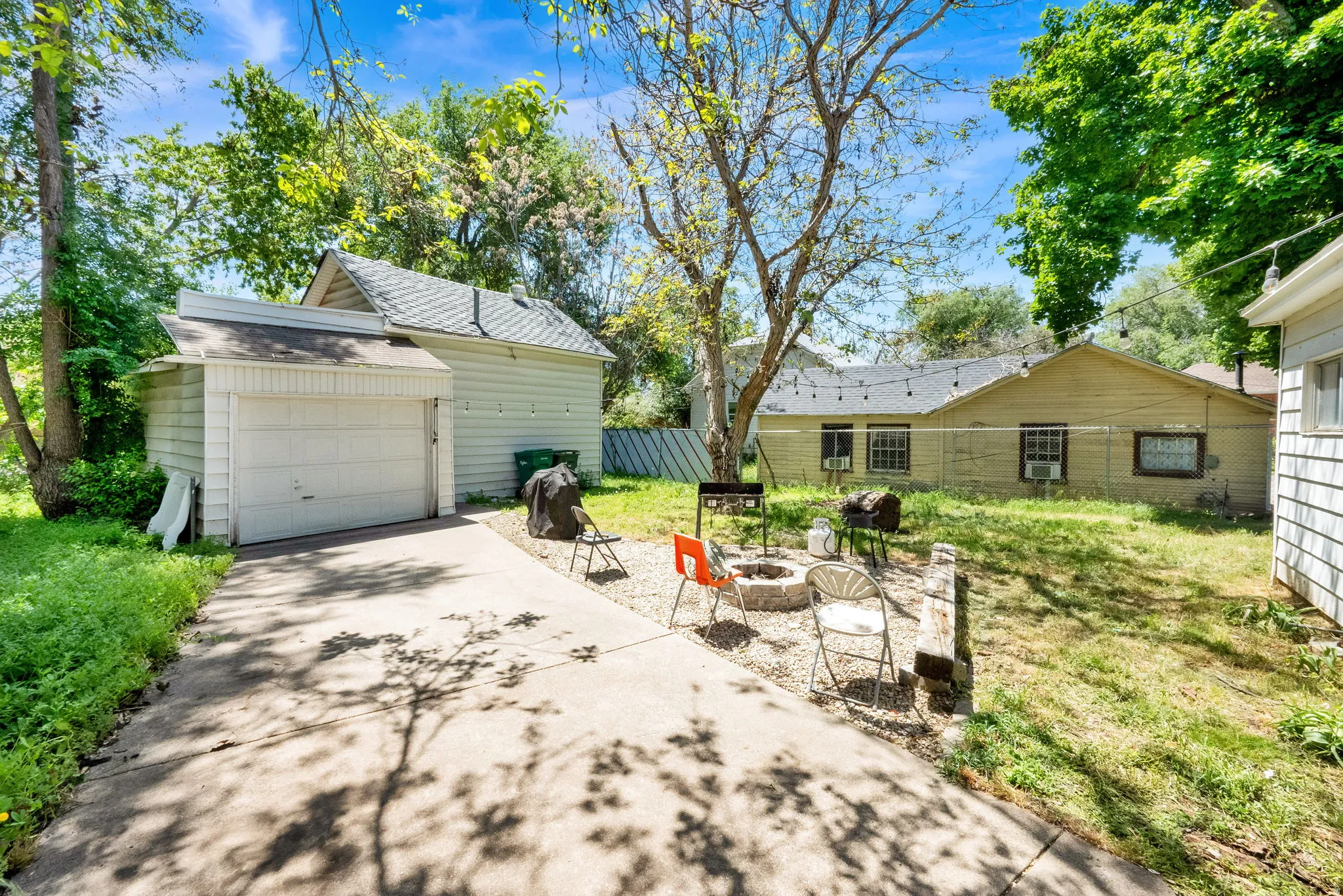 Concrete driveway leading to a detached garage