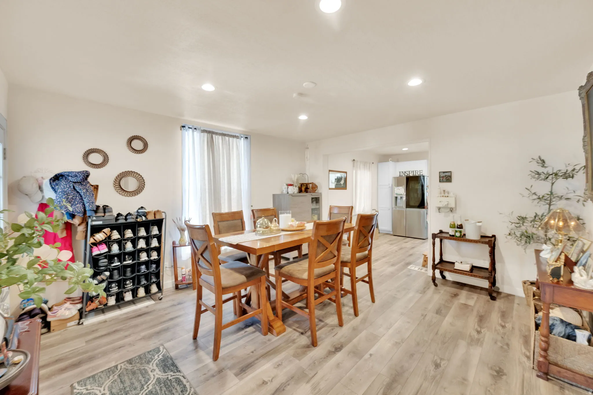 Open-concept living space with wood-finish flooring, recessed lighting, and a neutral color palette