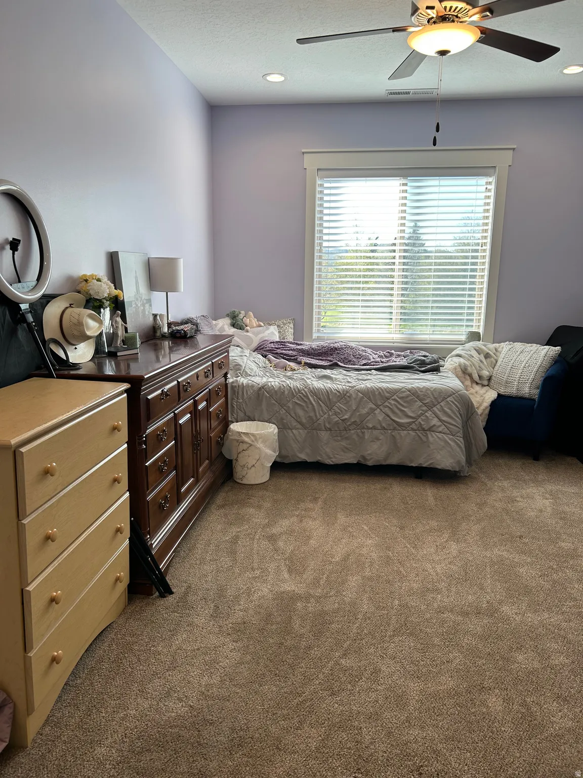 Carpeted room featuring a ceiling fan with integrated lighting, recessed lighting, and a large window with blinds