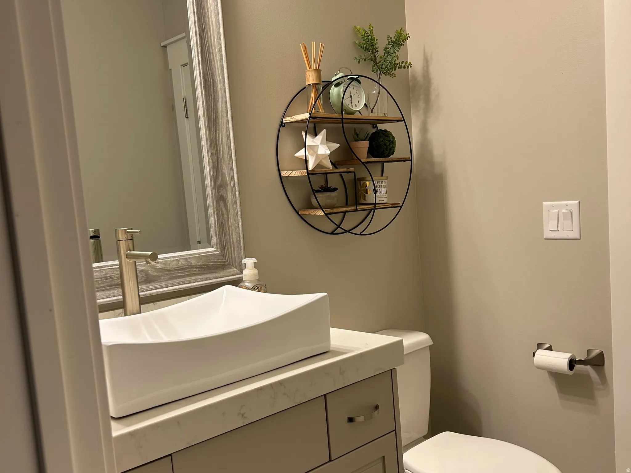 Modern vanity with a rectangular vessel sink, solid surface countertop, and brushed nickel faucet