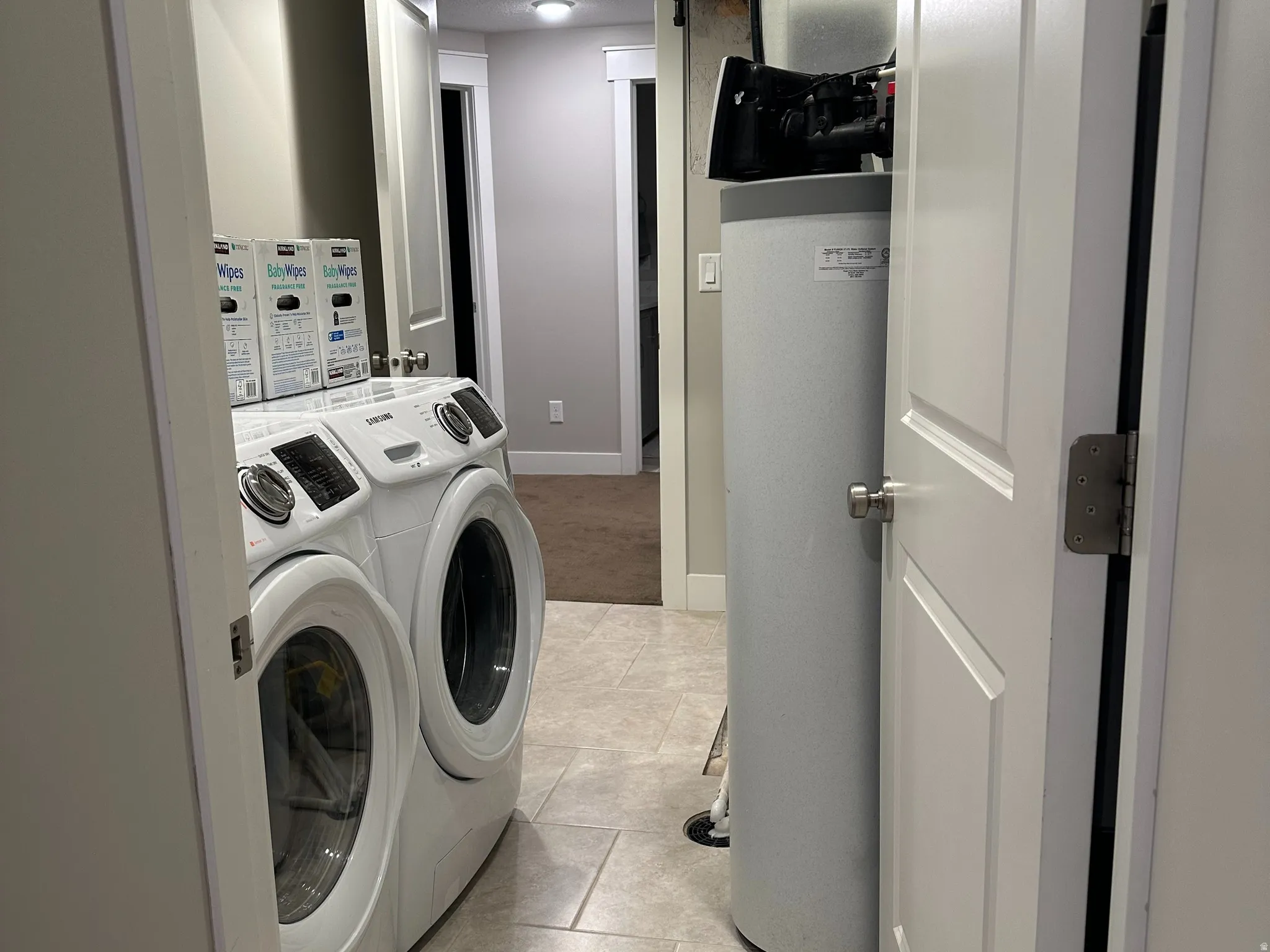 Laundry area featuring tile flooring, recessed lighting, and a water softener