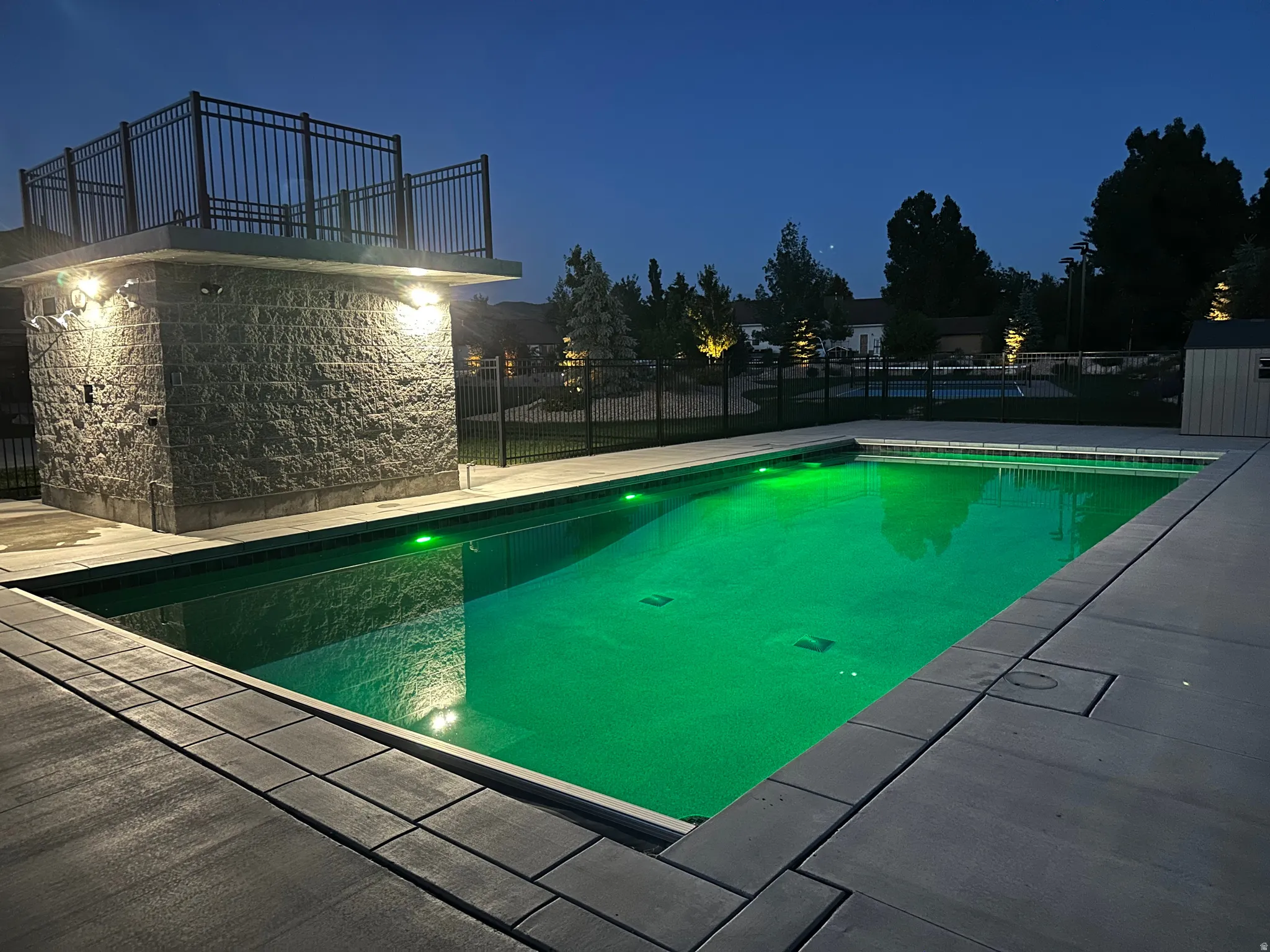 Rectangular inground pool with green accent lighting