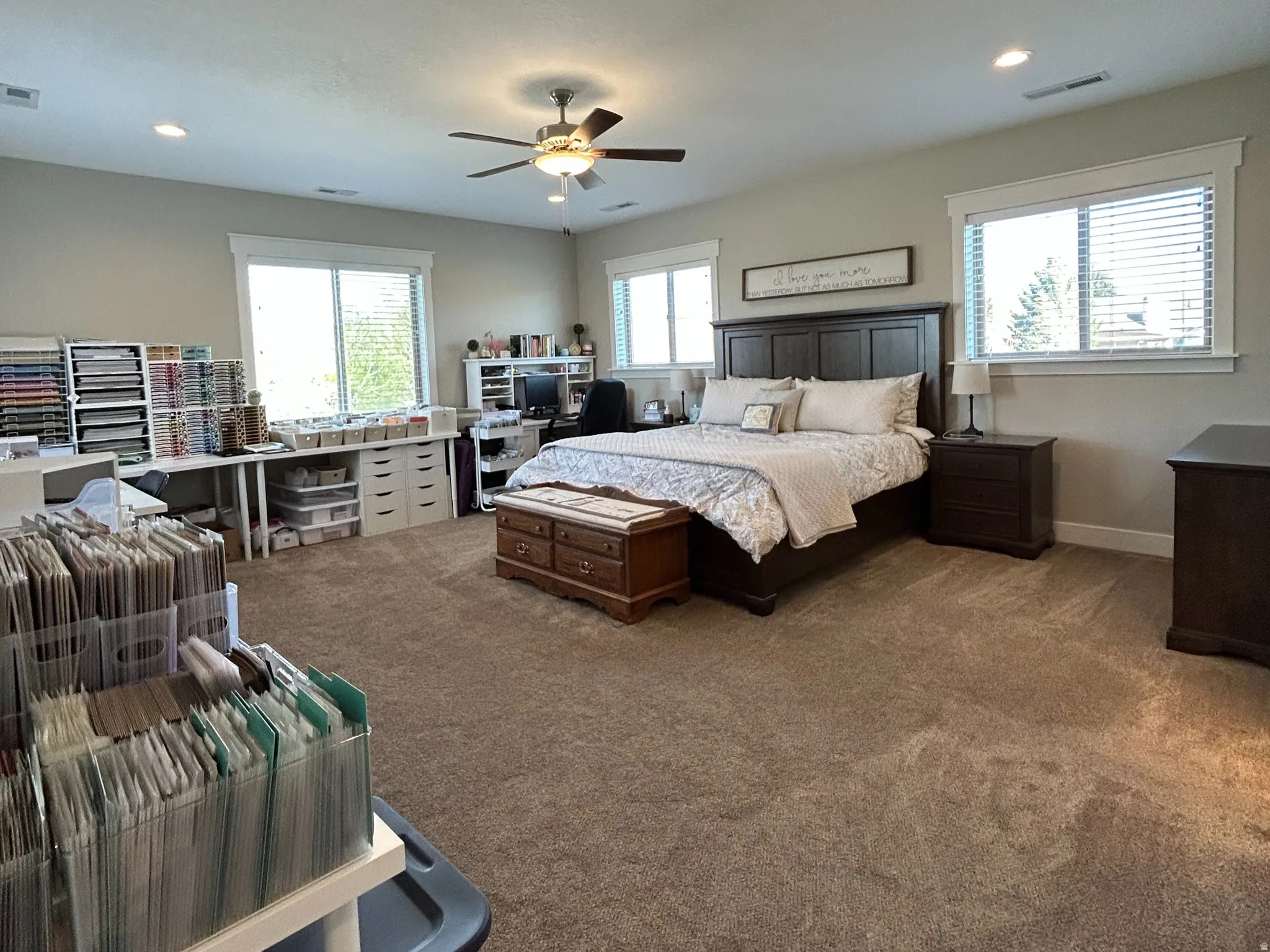 Spacious room featuring neutral carpeting, recessed lighting, and a ceiling fan
