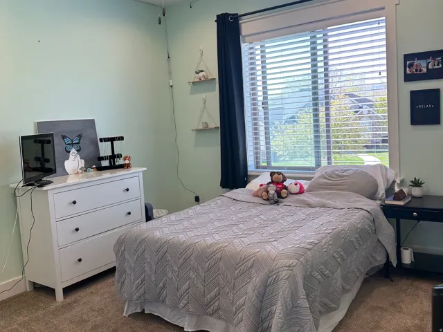 Carpeted room featuring a ceiling fan with integrated lighting, recessed lighting, and a window with blinds