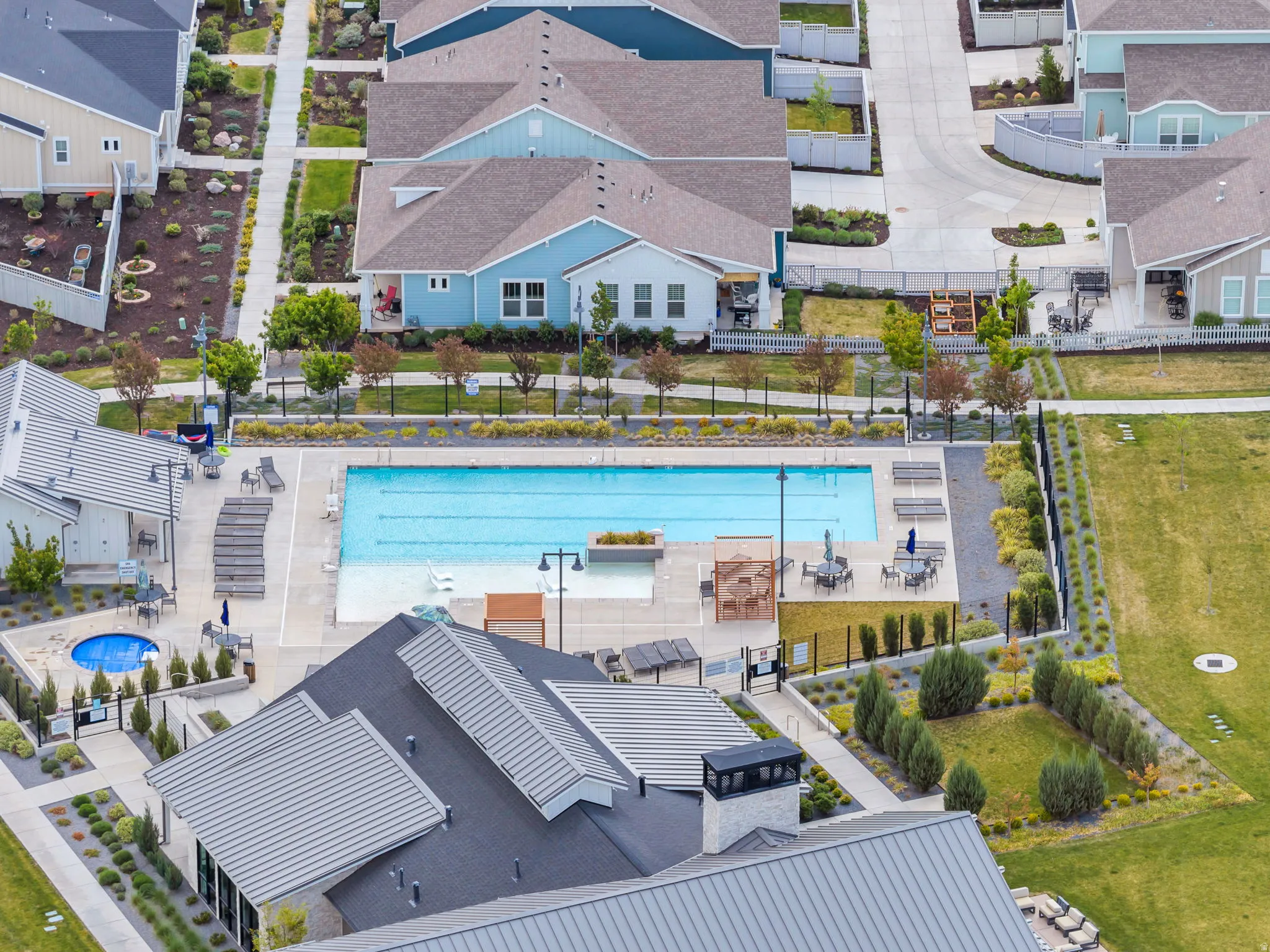 Aerial perspective showcasing a community swimming pool, integrated spa, and recreation center.
