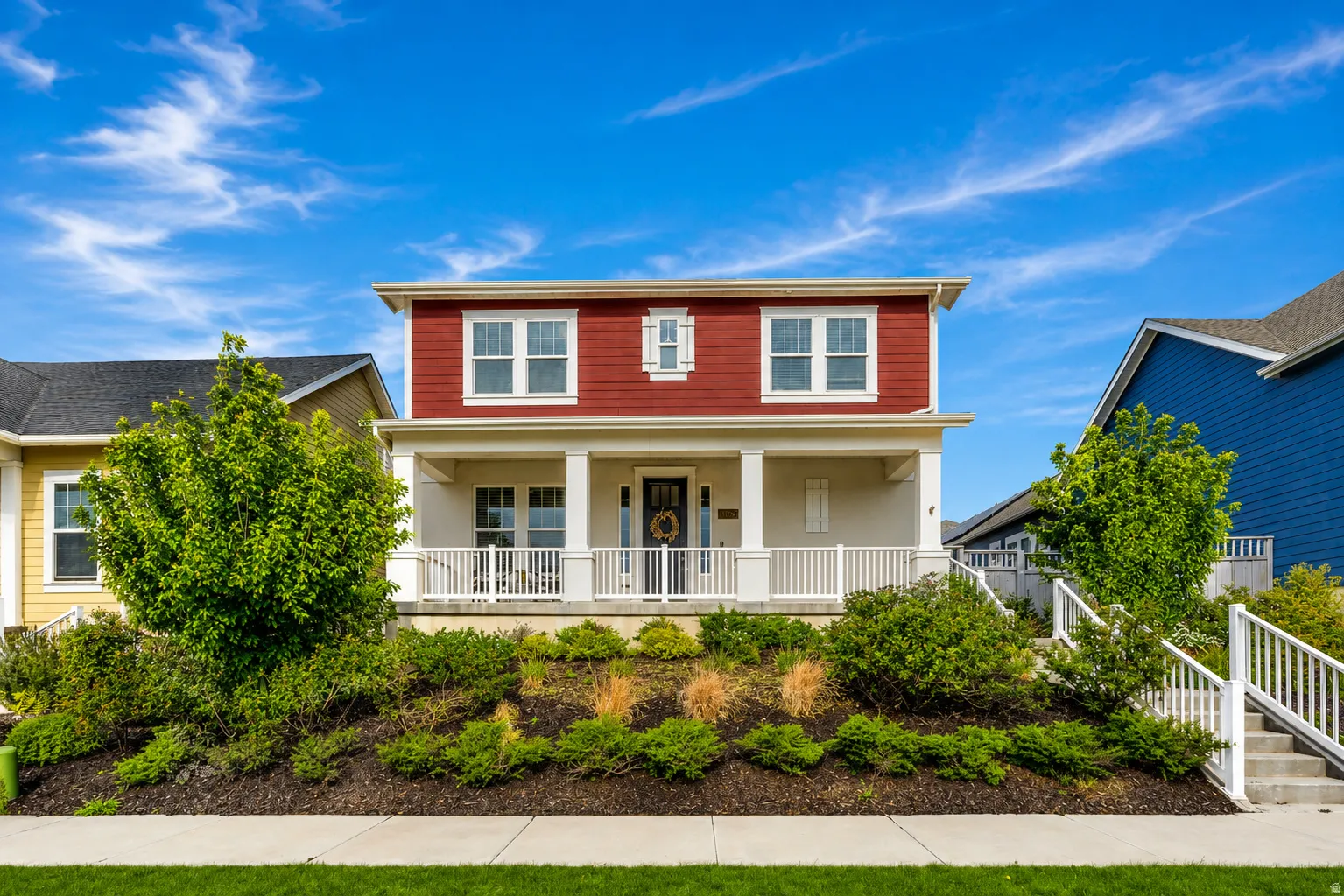 Two-story home featuring red horizontal siding and white trim